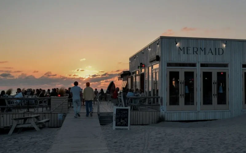 Enjoy outdoor dining with a stunning sunset view at the Mermaid restaurant in Liepāja, Latvia.
