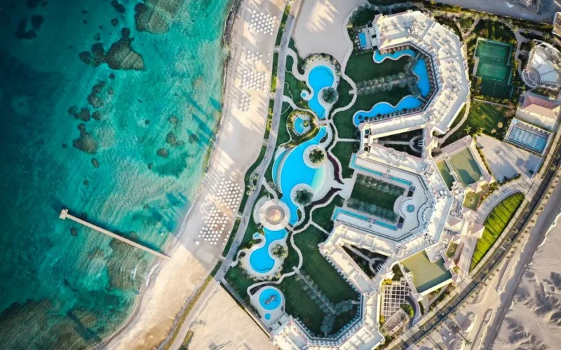 Stunning aerial view of a luxury resort in Hurghada, featuring pools and beach by the Red Sea.