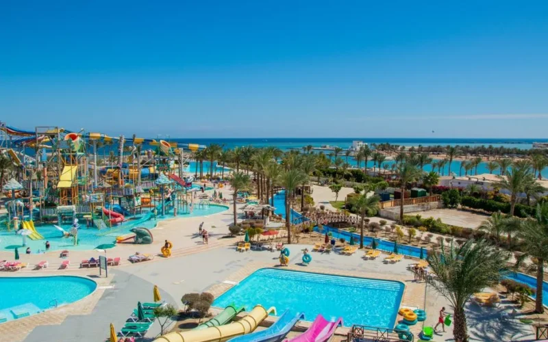 Aerial view of a lively tropical water park by the sea, perfect for family fun under the sun.