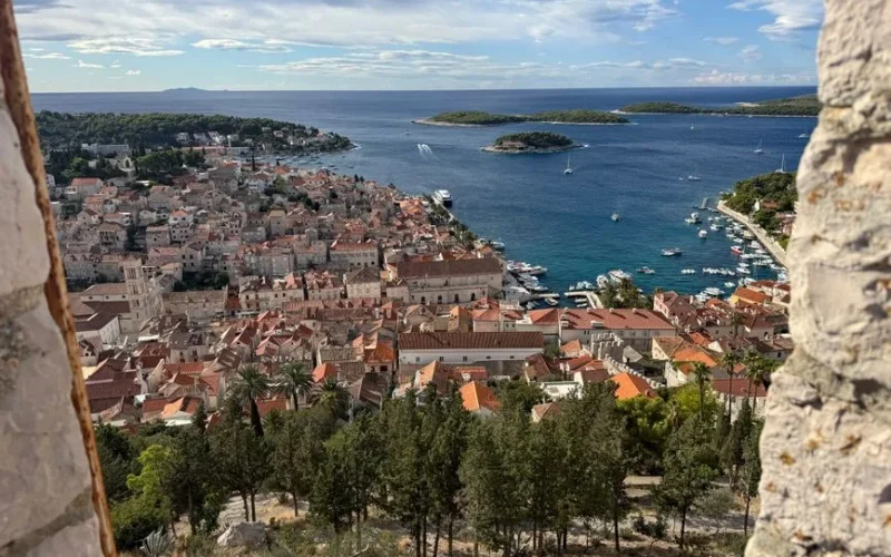 Aerial view of Hvar Town overlooking the Adriatic Sea with islands and yachts.