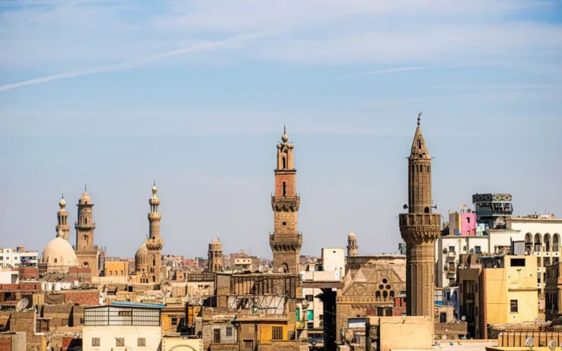 A captivating view of Cairo's skyline featuring historic mosques and minarets under a clear blue sky.