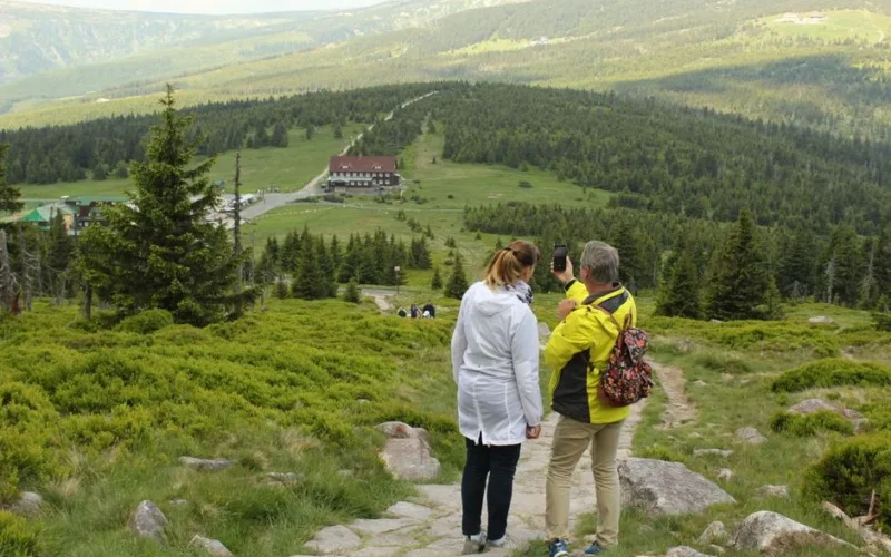 Couple hiking and capturing scenic views in Jelenia Góra, Poland.