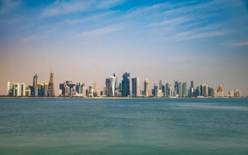 Captivating view of Doha skyline from the Corniche, featuring modern architecture under a clear blue sky.