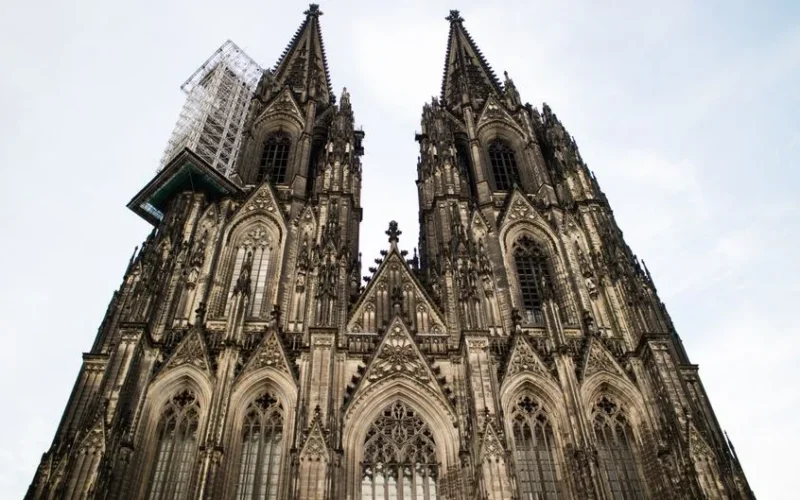 Stunning Gothic architecture of Cologne Cathedral in Germany against a clear sky.