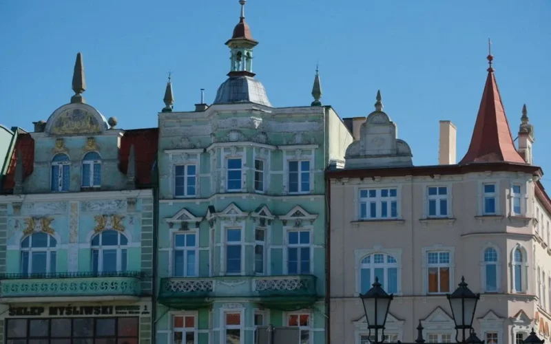Beautiful historic European buildings with ornate facades under a clear blue sky.