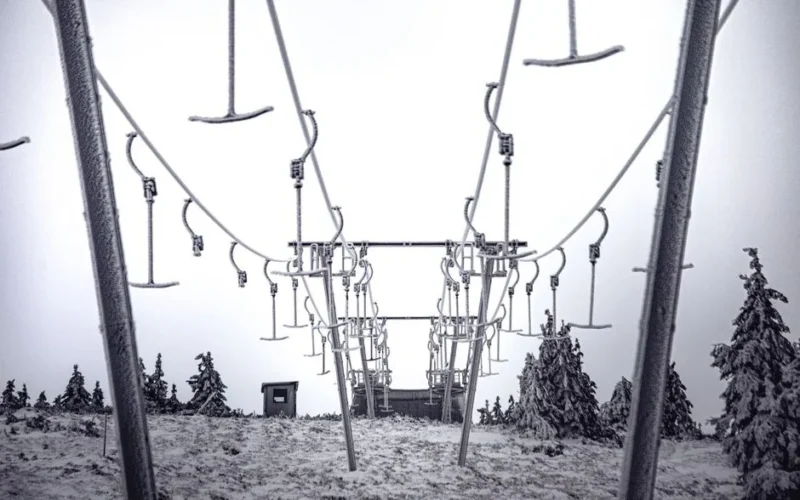 Snow-covered ski lift in Karkonosze National Park, Poland, capturing a winter landscape.