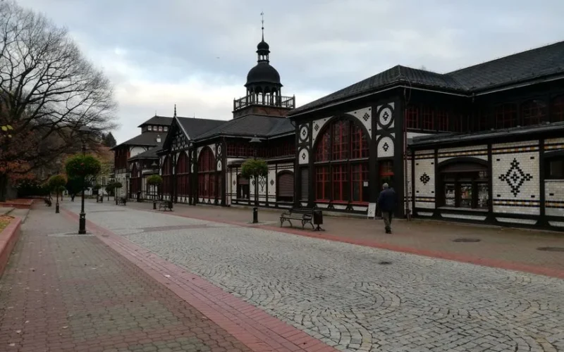 Charming historic architecture along cobblestone street in Dolny Śląsk, Poland, during a quiet day.