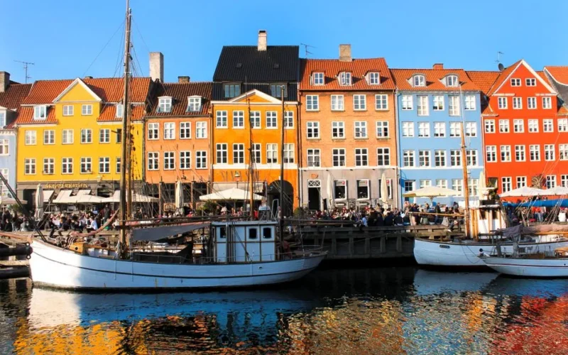 Vibrant historic buildings and boats at Nyhavn Canal in Copenhagen, Denmark.