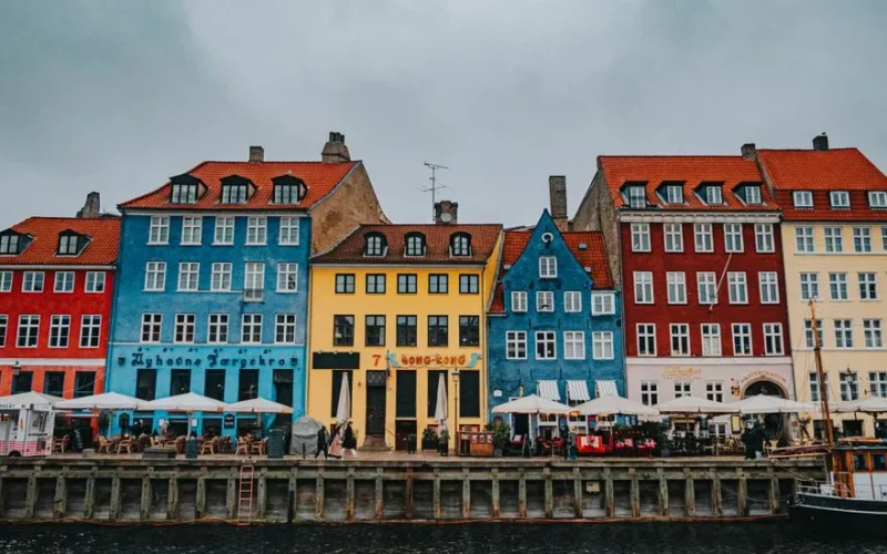 Vibrant Nyhavn harbor in Copenhagen showcasing colorful historic buildings by the water.
