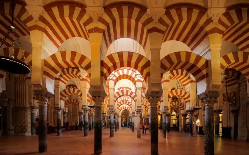 Explore the iconic striped arches of the Mezquita-Catedral in Córdoba, Spain.