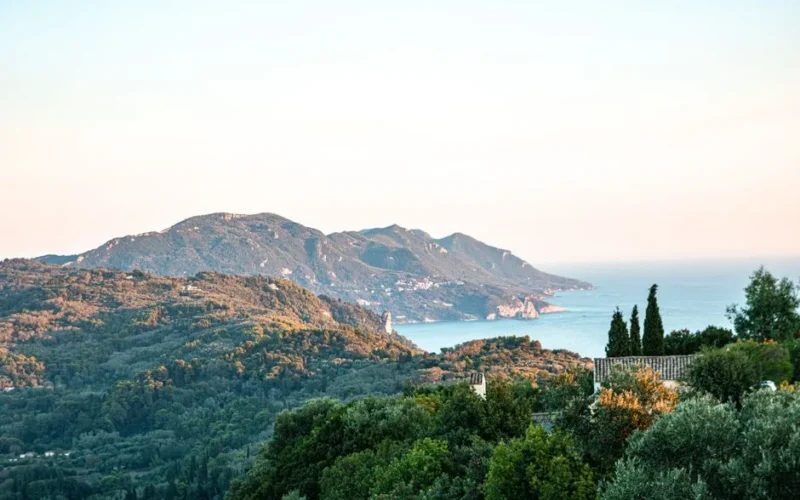 Breathtaking landscape view of Korfu, Greece, showcasing lush greenery and the Mediterranean Sea.