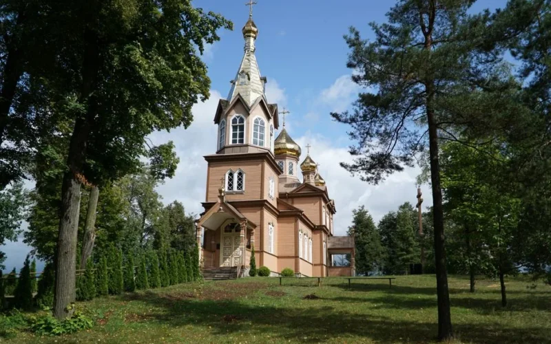 St. Nicolas Orthodox Church in Michalowo, a wooden marvel surrounded by lush greenery.