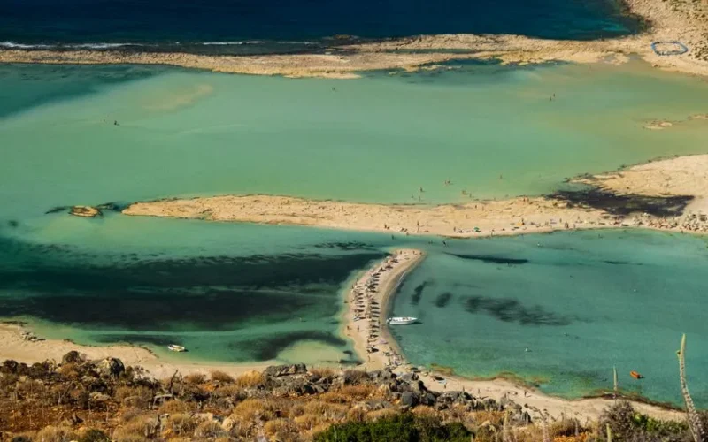 A stunning aerial view of Balos Beach Lagoon, featuring turquoise waters and a sandy shore.