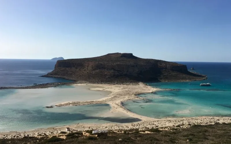 A beautiful aerial shot of Balos Lagoon in Chania, Greece capturing the clear turquoise waters and scenic coastline.