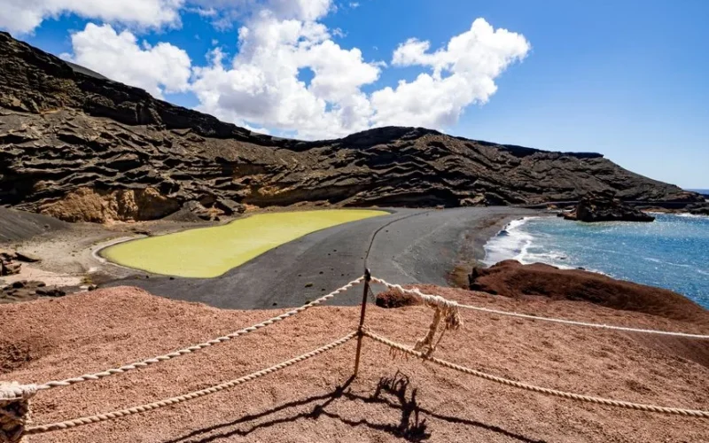 Stunning view of El Golfo's green lagoon and black sand beach in Lanzarote, with unique volcanic landscape.
