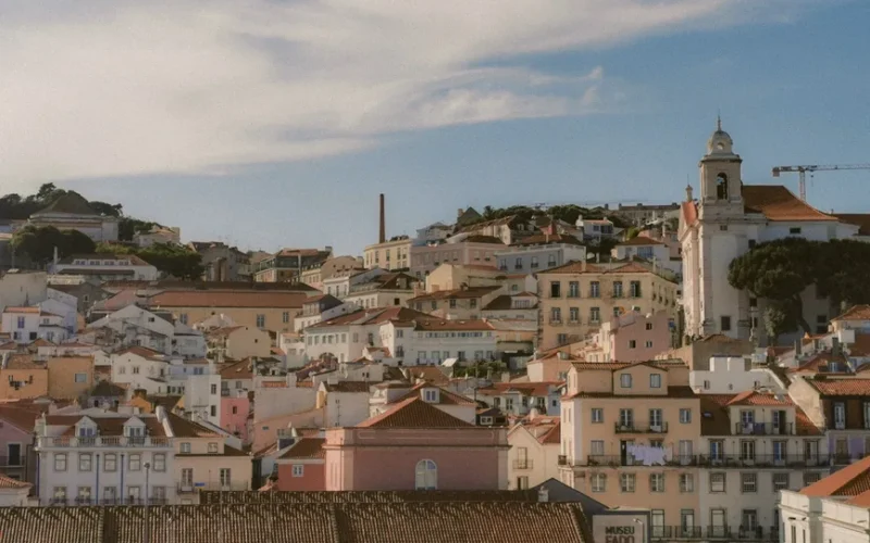 Aerial view of Lisbon's charming historic architecture under a bright sky.