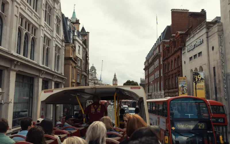 View from a double-decker bus touring central London with Big Ben in the distance.