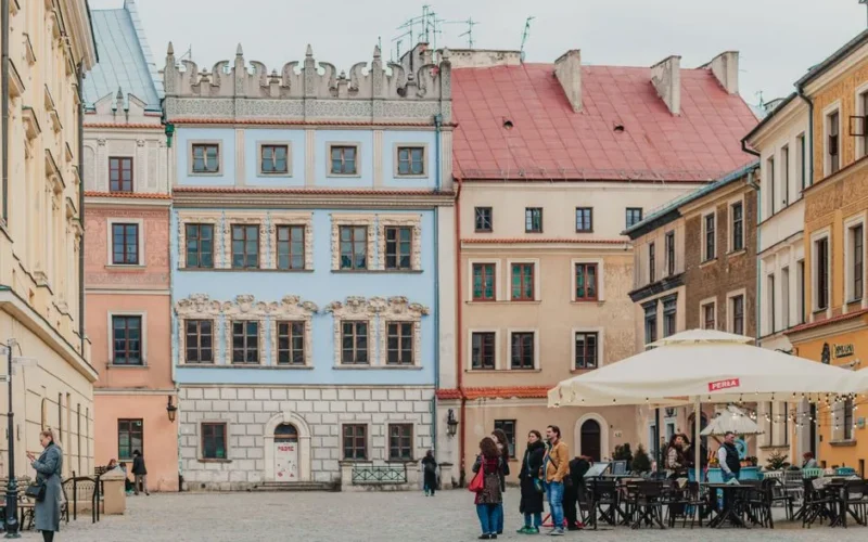 Picturesque square with colorful historic buildings and outdoor cafes in Lublin's Old Town.