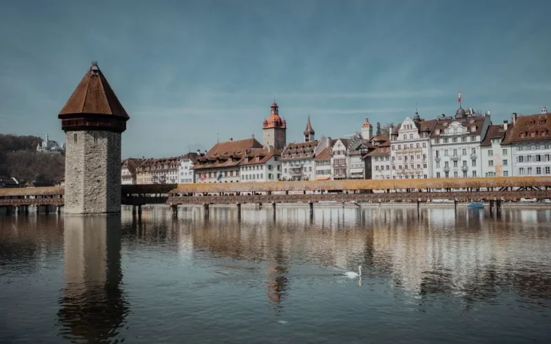 Scenic view of Chapel Bridge and the Water Tower reflecting in Lake Lucerne, Switzerland.