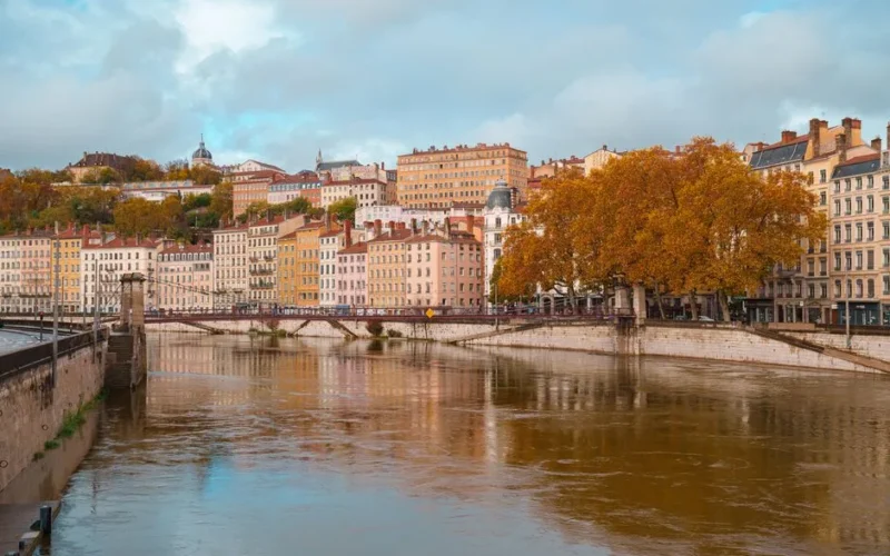 Beautiful autumn scene of the Saône River and Lyon's architecture in Auvergne-Rhône-Alpes, France.
