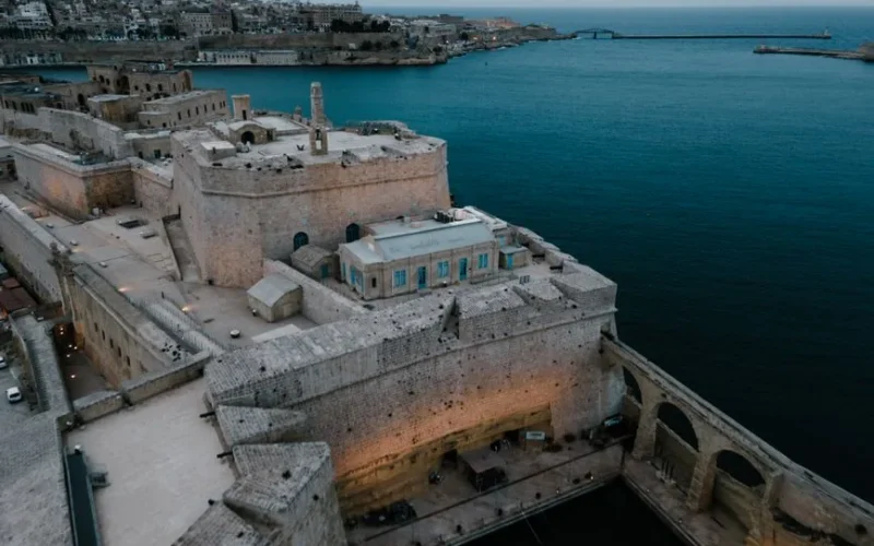 Drone shot of the historic Fort Saint Angelo overlooking the sea in Il-Birgu, Malta.