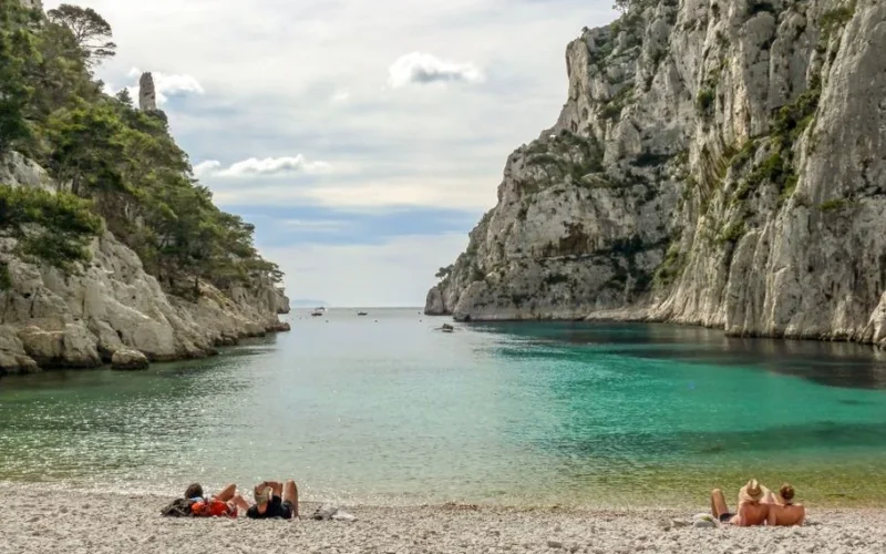 A serene day at Calanque beach with turquoise waters and dramatic cliffs in Marseille, France.