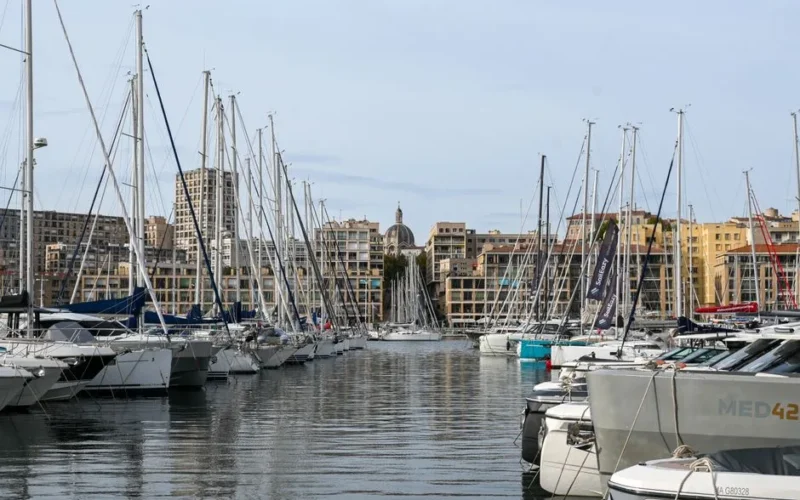 Stunning view of sailboats docked at the Old Port of Marseille with cityscape backdrop.