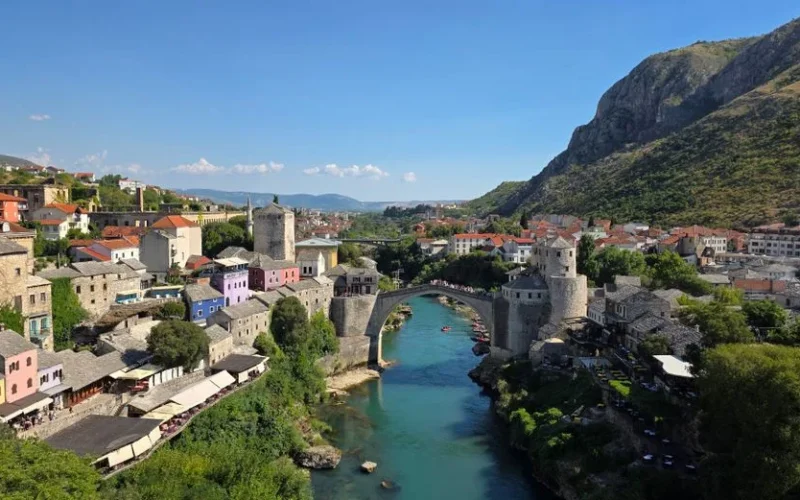 Explore the historic Old Bridge in Mostar, Bosnia and Herzegovina, surrounded by picturesque architecture.