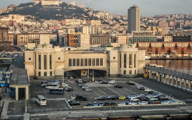 Panoramic view of Naples harbor with the city and Castle Sant'Elmo in the background.
