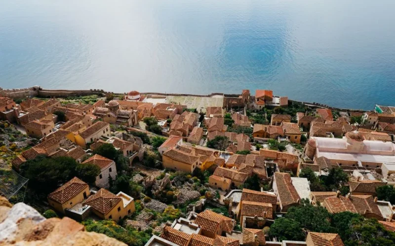 Discover the stunning aerial view of Monemvasia's historic architecture framed by the serene Mediterranean Sea.