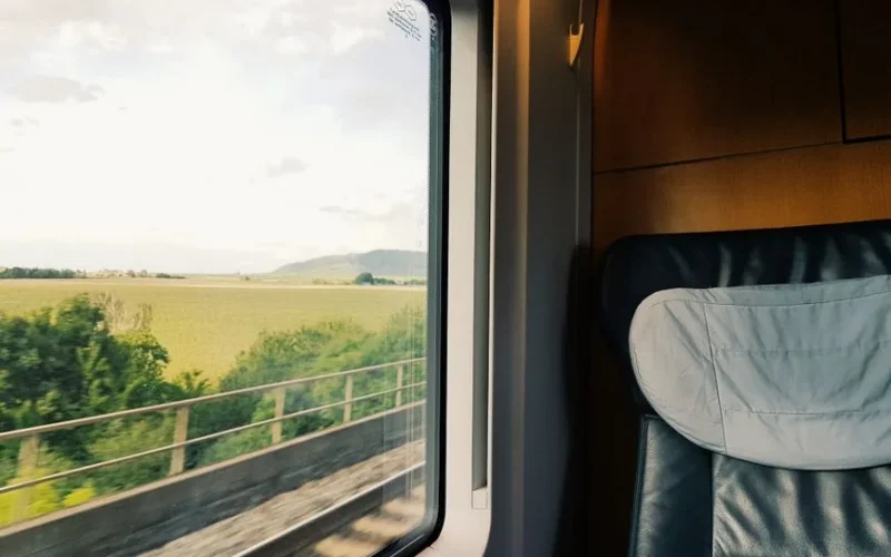 Captivating view of the countryside from a train window during daylight.