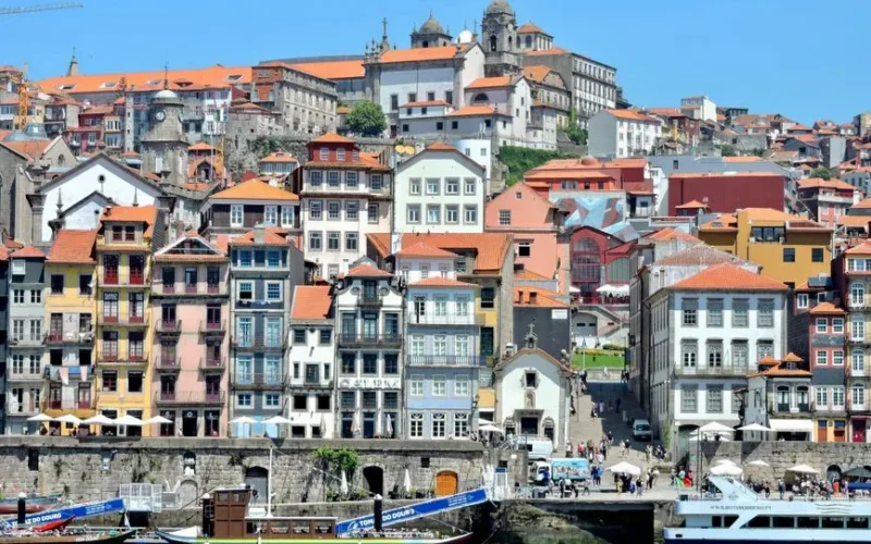 A vibrant view of the historic Ribeira District along the Douro River in Porto, Portugal.