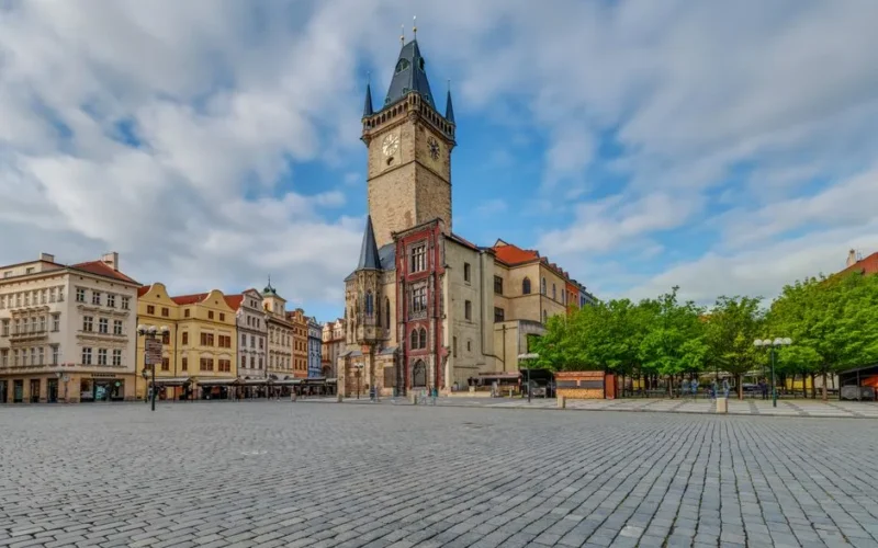 Scenic view of the iconic Old Town Square in Prague featuring historic architecture and the town hall tower.