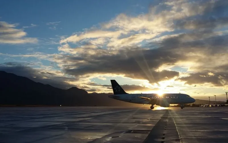A beautiful silhouette of an airplane on a runway during a vibrant sunset at Čilipi Airport, Croatia.