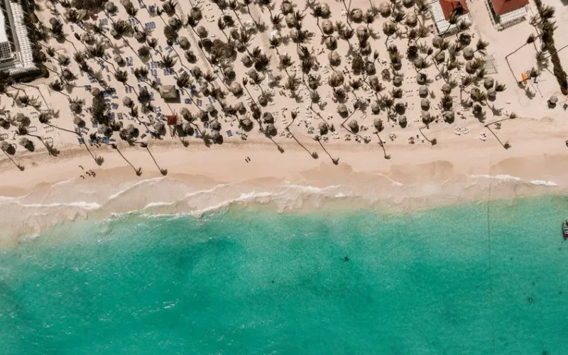 Stunning aerial view of a tropical beach in the Dominican Republic with white sand and turquoise water.