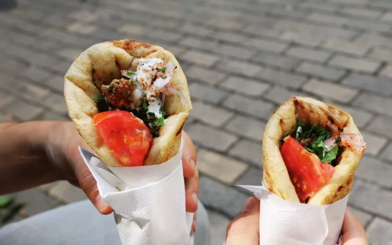 Two fresh gyros with tomato and herbs, perfect Greek street food for a sunny day.