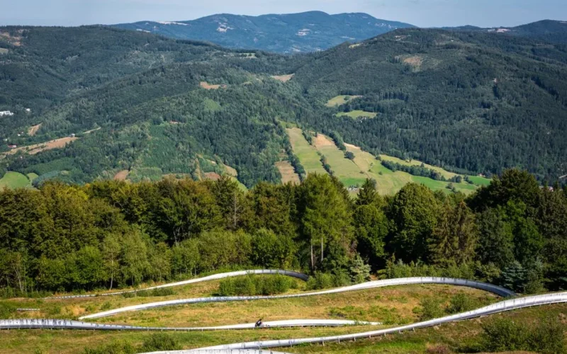 Breathtaking aerial view of lush green mountains and winding paths in Poland.