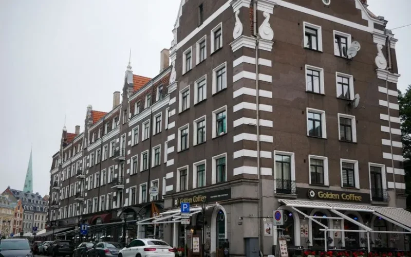Street view of classic European architecture in Riga with cafe and cobblestone street.