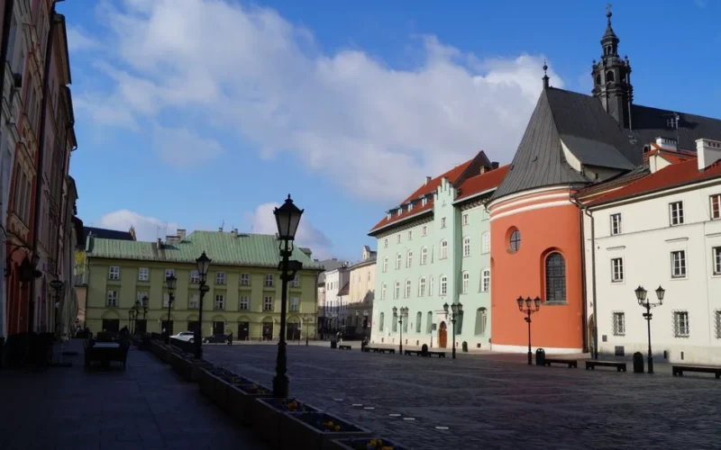 Discover the beauty of Kraków's Small Market Square with colorful townhouses and Renaissance architecture.