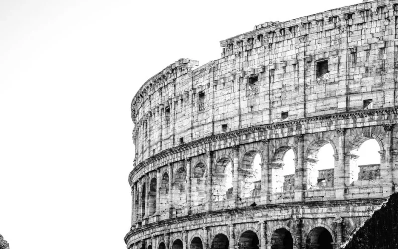 Stunning black and white image capturing the grandeur of the Roman Colosseum's architecture.
