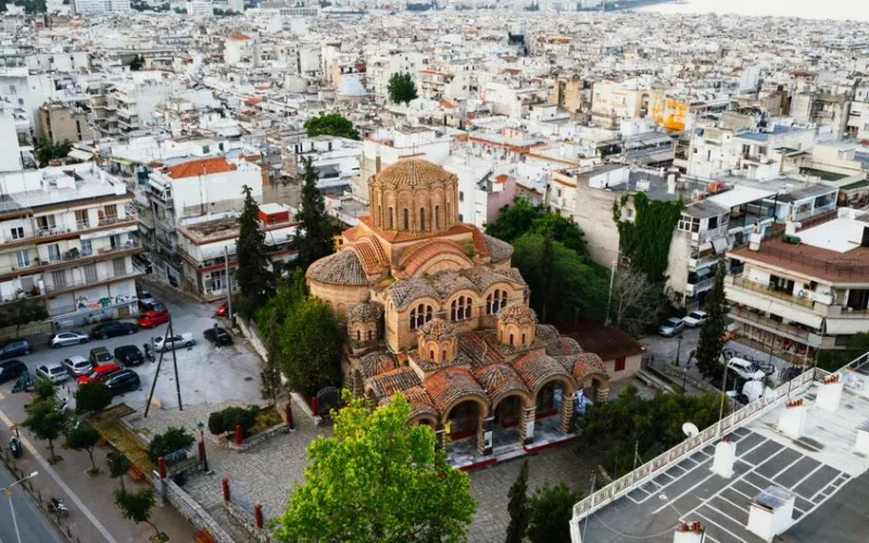 Capture of a Byzantine church in Thessaloniki, Greece from above, surrounded by city buildings.