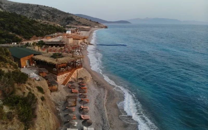 Stunning aerial shot of a serene beach resort in Albania, featuring turquoise waters and scenic coastline.