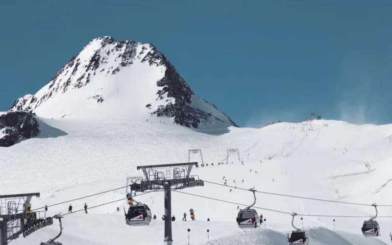 Scenic view of snow-covered mountains and cable cars at Soelden ski resort in winter.