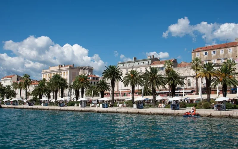 Captivating view of Split's waterfront promenade with palm trees and historic buildings.