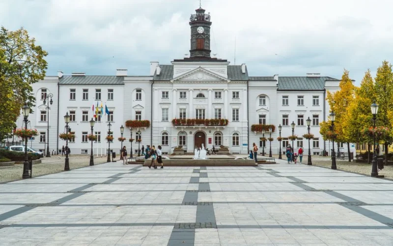 View of the historic town hall in Plock, Poland, showcasing classic architecture and city square.