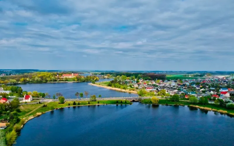 Beautiful aerial view of Niasviž town and lake with lush greenery in Belarus.