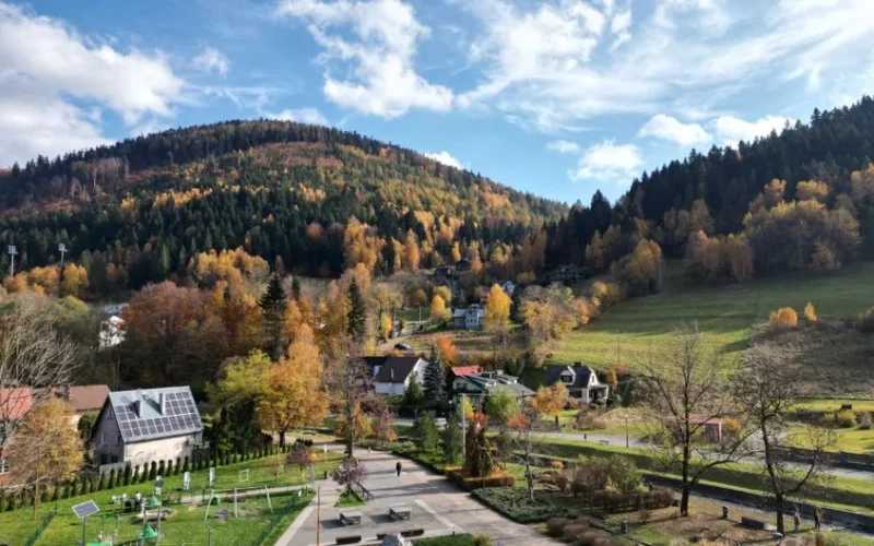 Captivating autumn scenery in Szczyrk, Poland with colorful forests and quaint houses.