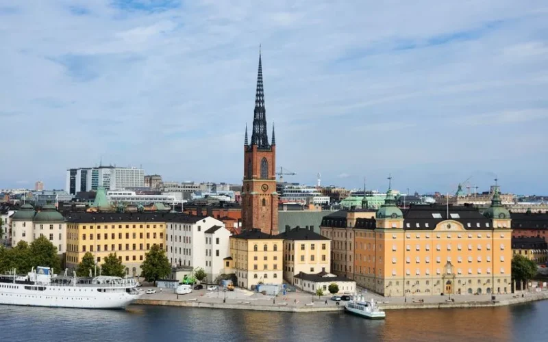 A stunning view of Riddarholmen Church and colorful buildings in Stockholm, Sweden.