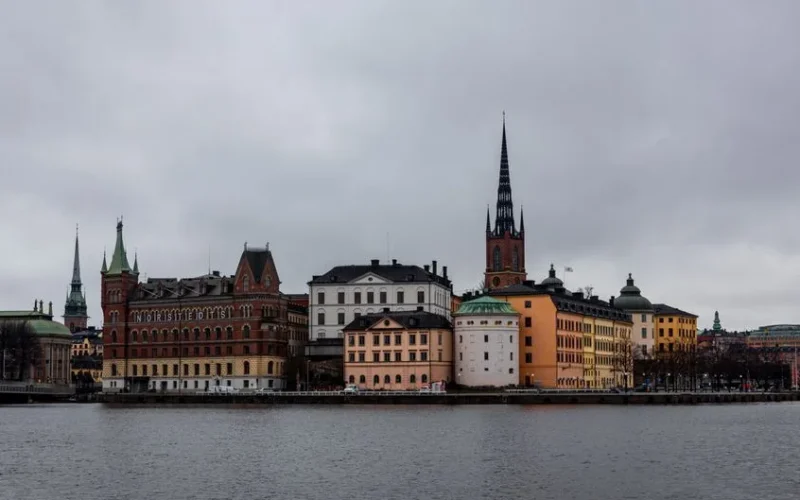 View of historic buildings along the Stockholm waterfront, showcasing Riddarholmen Church.