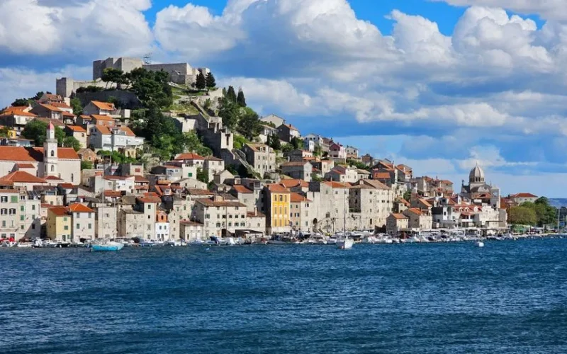 Panoramic view of Šibenik, Croatia with stone houses and blue Adriatic Sea.